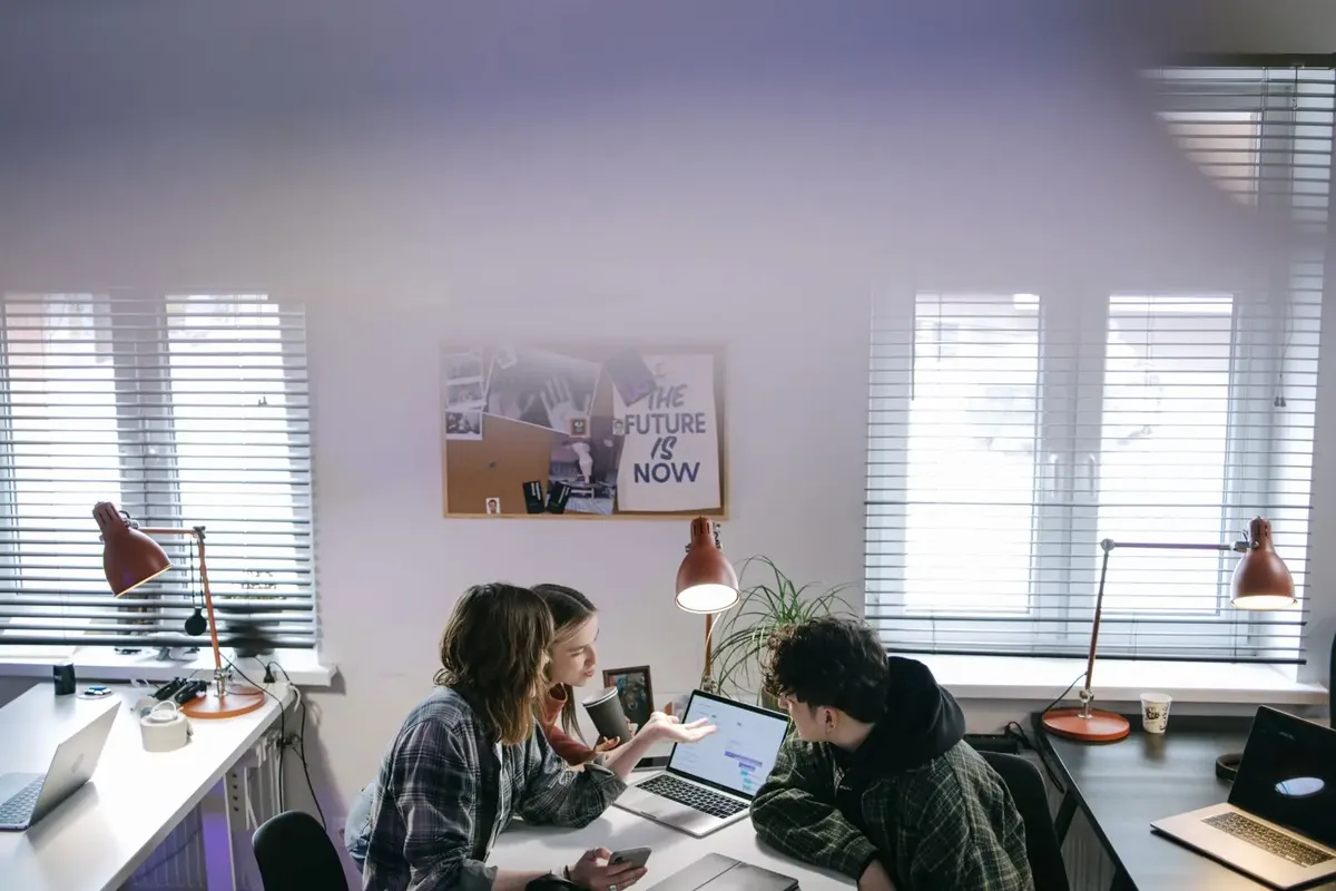 Stock photo: colleagues working together at laptops, the kind of company team that orders from a B2B print store