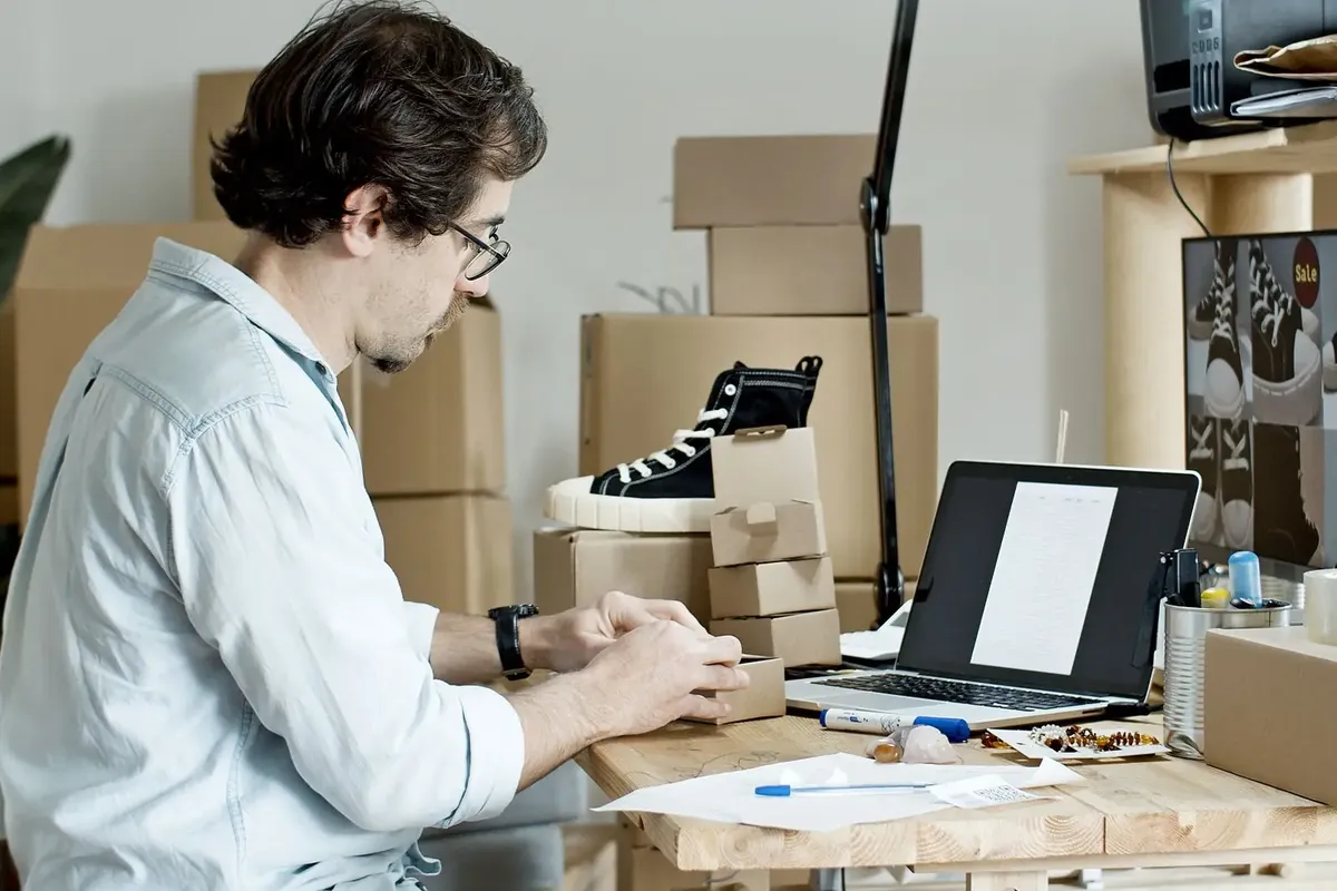 Stock photo: printed orders being packed at a desk for delivery to a business buyer