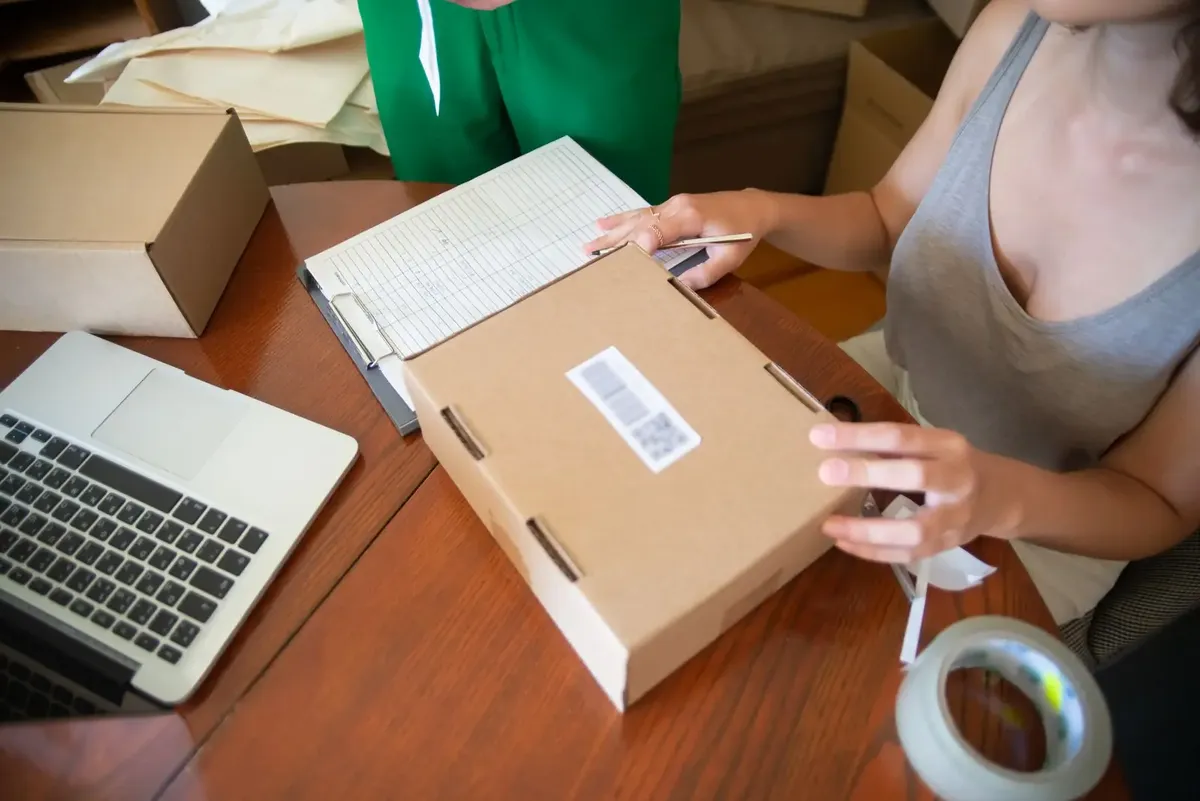 Stock photo: a seller packing an online order, one sub-order of a buyer's marketplace order